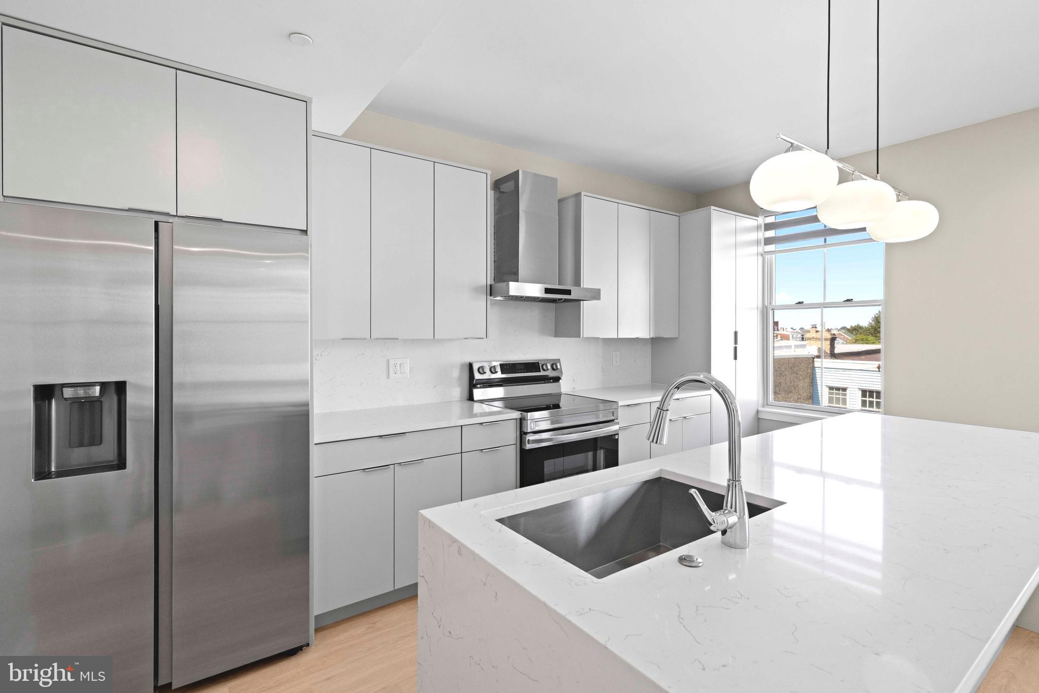 4720 Richmond Street, Unit 4 Philadelphia, PA 19137 - Photo 8 of 26 a kitchen with white cabinets and stainless steel appliances