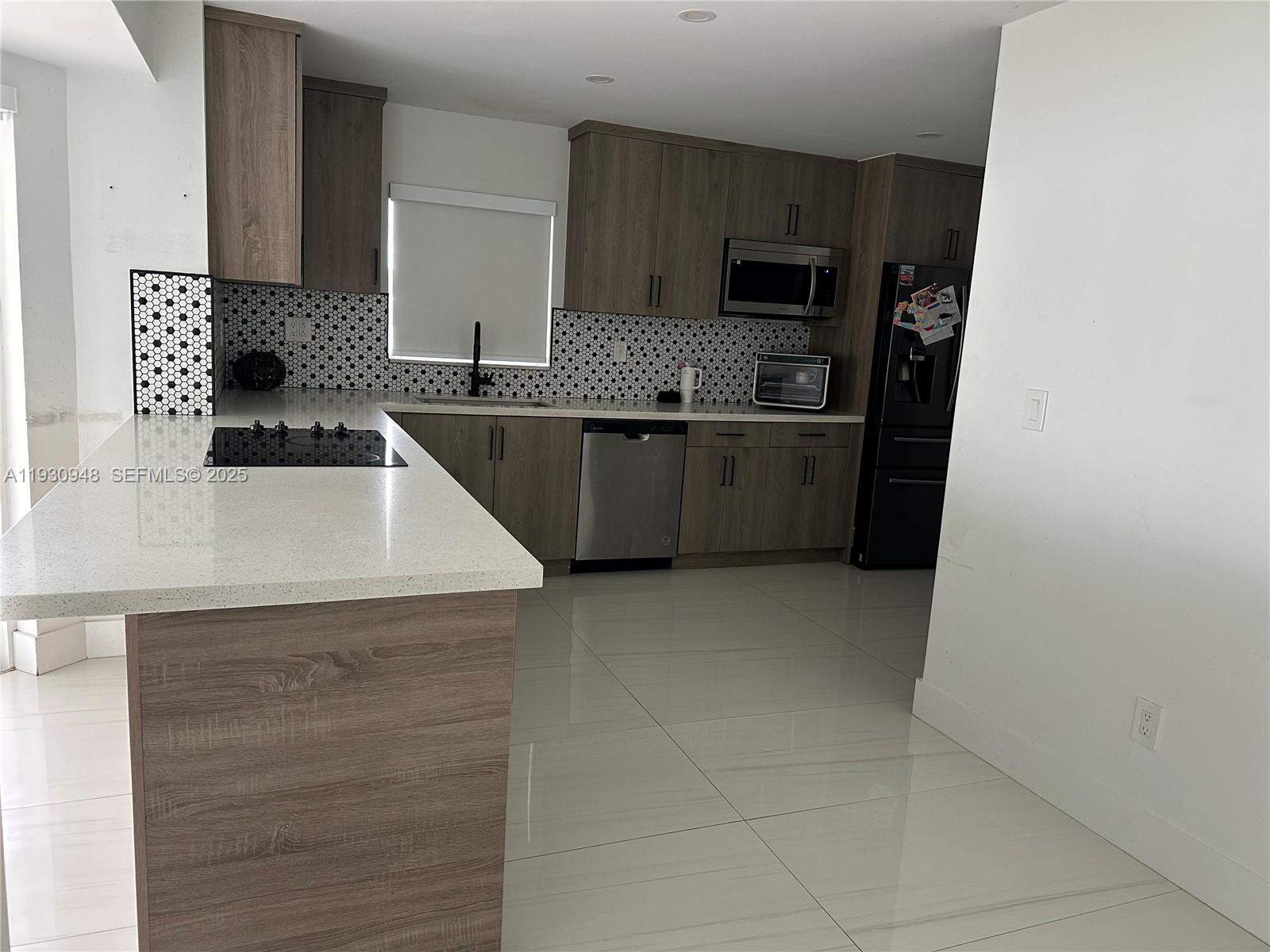 a kitchen with a sink a stove top oven a counter space and cabinets