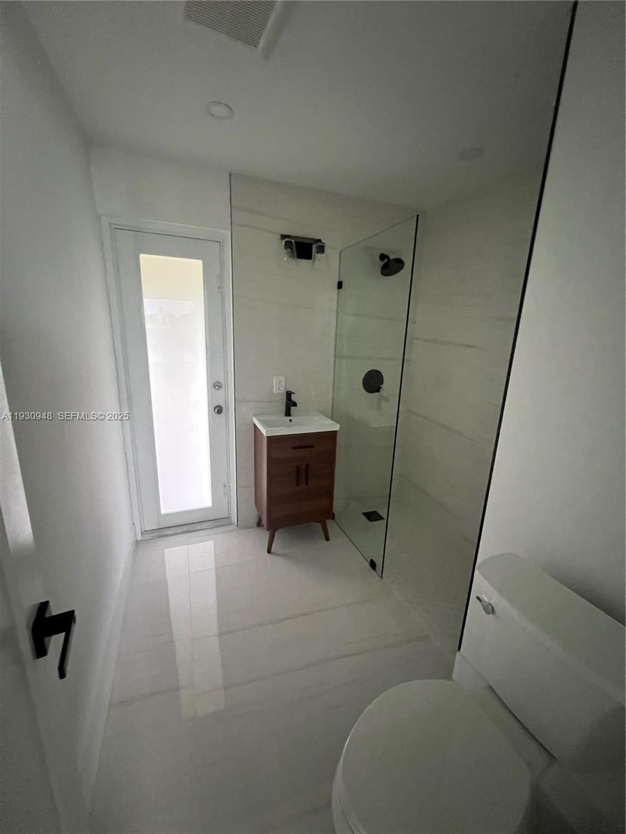 14830 Harding Lane Homestead, FL 33033 - Photo 11 of 12 a bathroom with a sink toilet and shower
