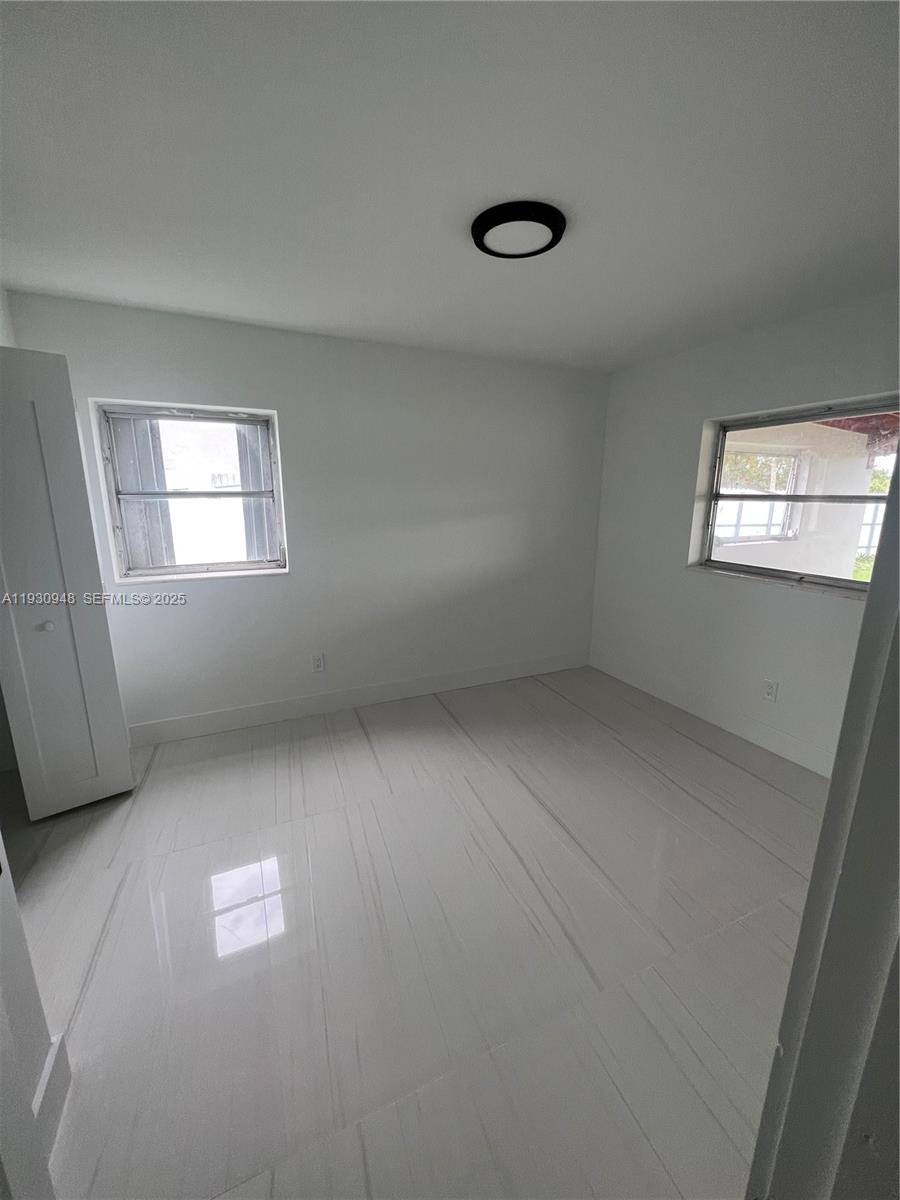 14830 Harding Lane Homestead, FL 33033 - Photo 12 of 12 wooden floor in an empty room with a window