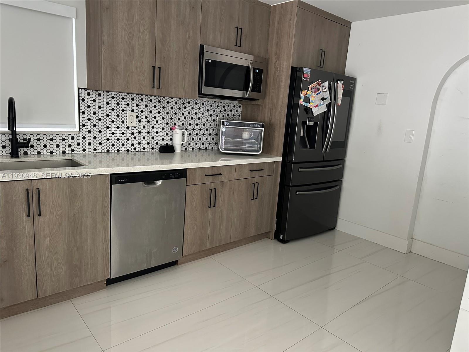 14830 Harding Lane Homestead, FL 33033 - Photo 3 of 12 a kitchen with stainless steel appliances a refrigerator and a sink