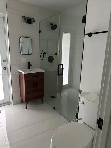 a bathroom with a toilet sink and shower