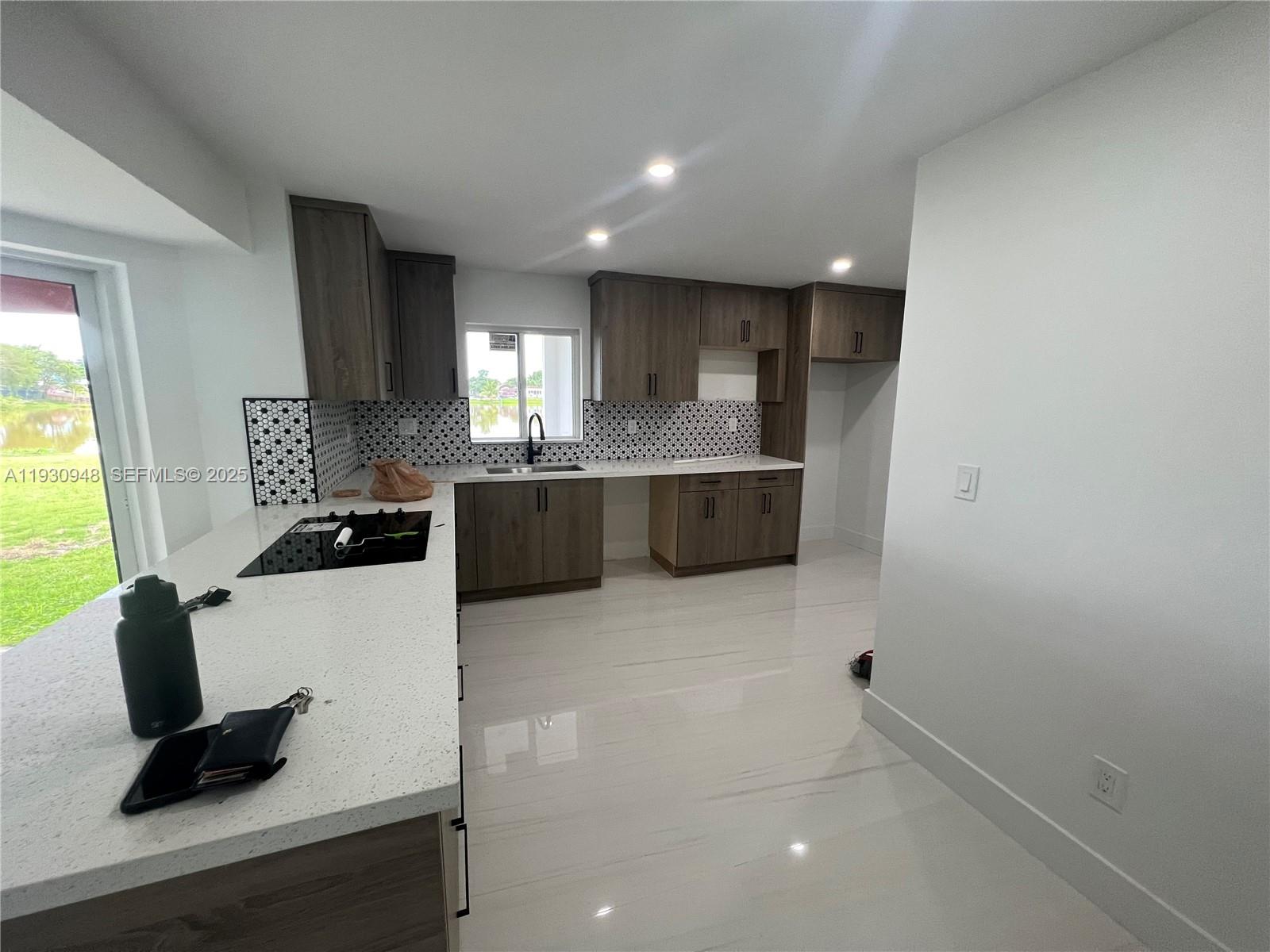 14830 Harding Lane Homestead, FL 33033 - Photo 5 of 12 a kitchen with stainless steel appliances a sink stove and cabinets