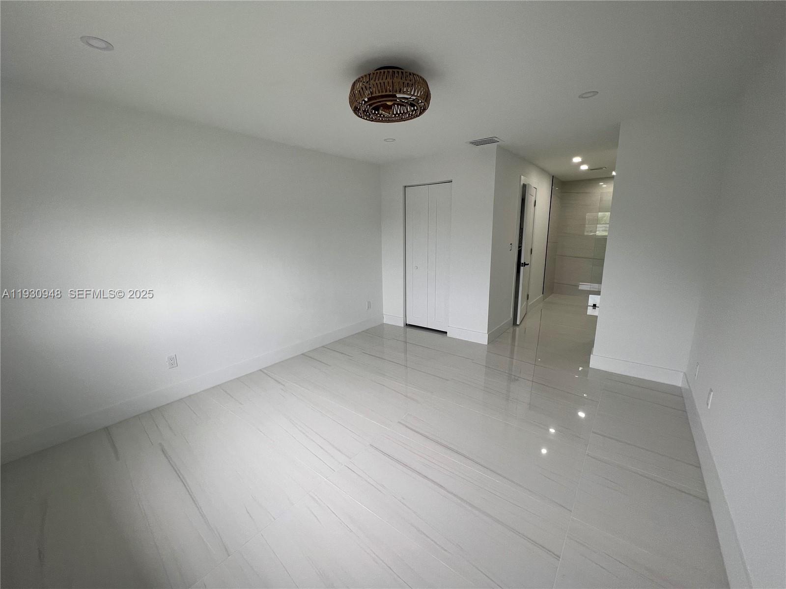 14830 Harding Lane Homestead, FL 33033 - Photo 7 of 12 an empty room with shelves and wooden floor