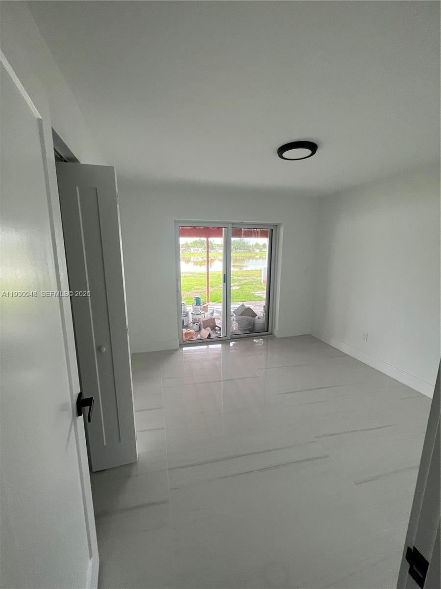 14830 Harding Lane Homestead, FL 33033 - Photo 9 of 12 a view of an empty room with a window