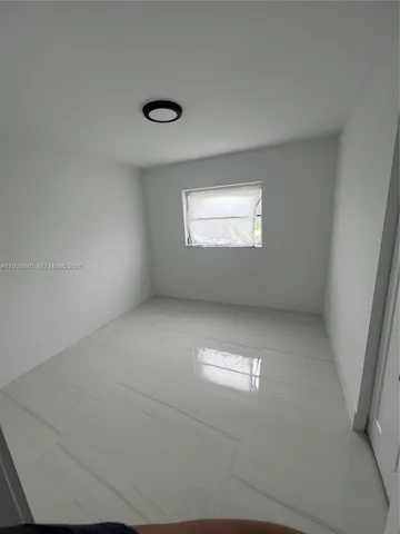 an empty room with a empty space and windows