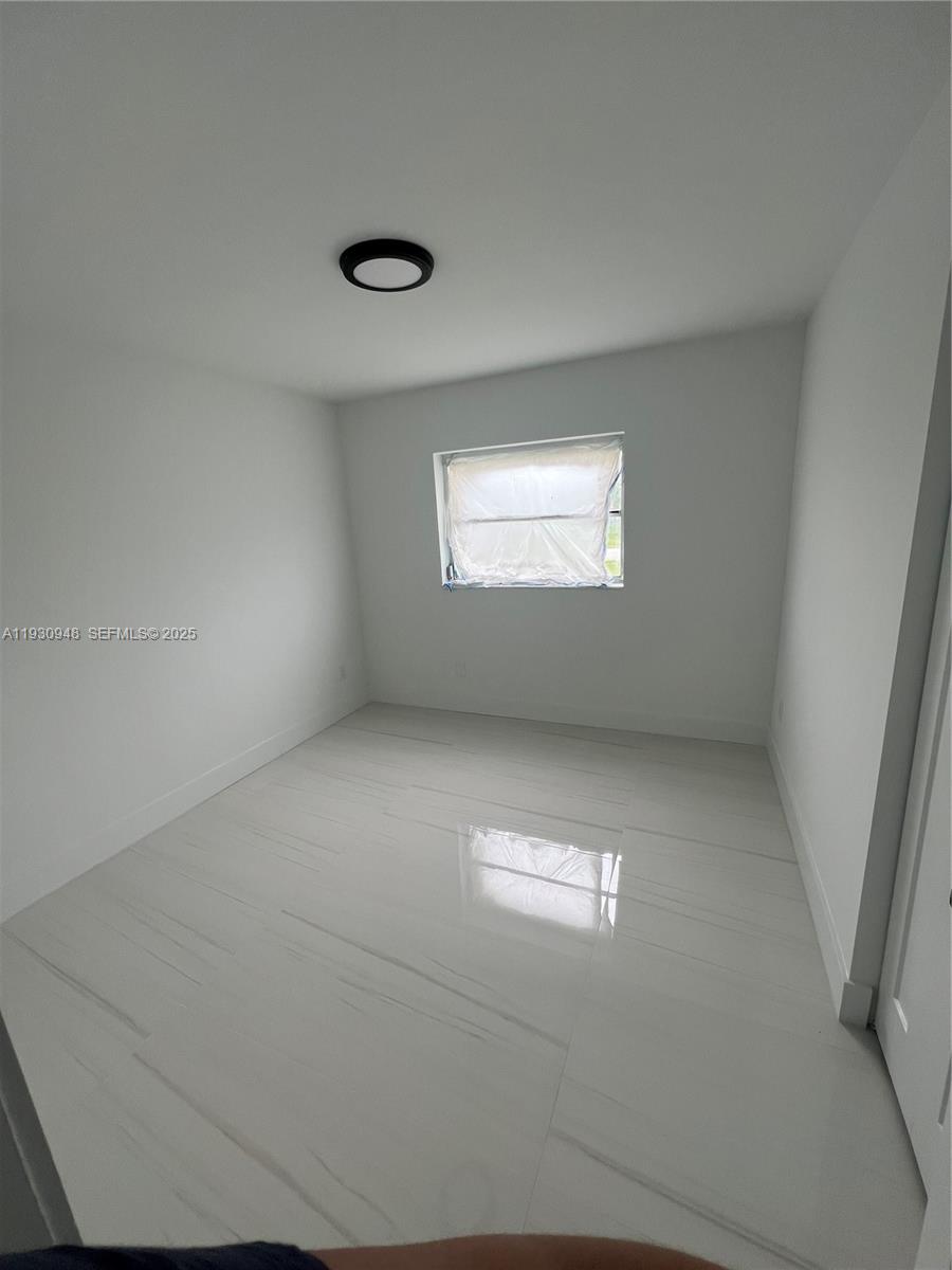 14830 Harding Lane Homestead, FL 33033 - Photo 10 of 12 an empty room with a empty space and windows