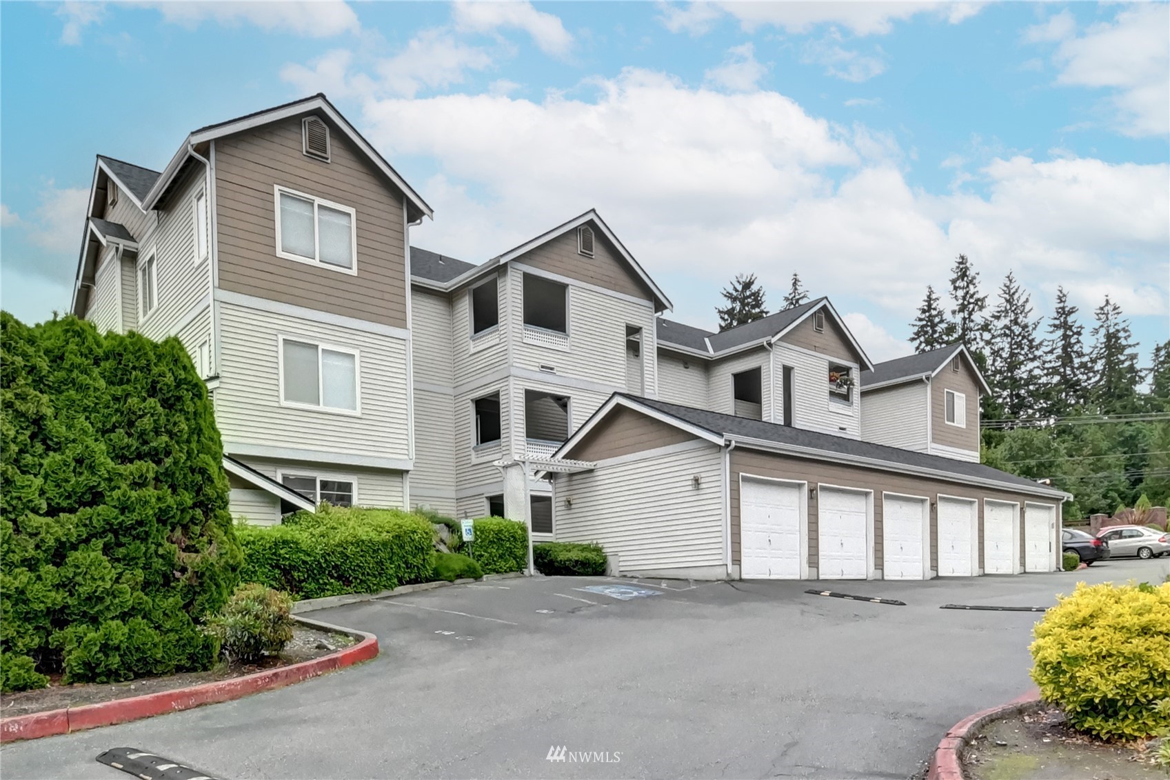 23908 Bothell Everett Highway, Unit B101 Bothell, WA 98021 - Photo 1 of 29 a front view of a house with a yard and garage