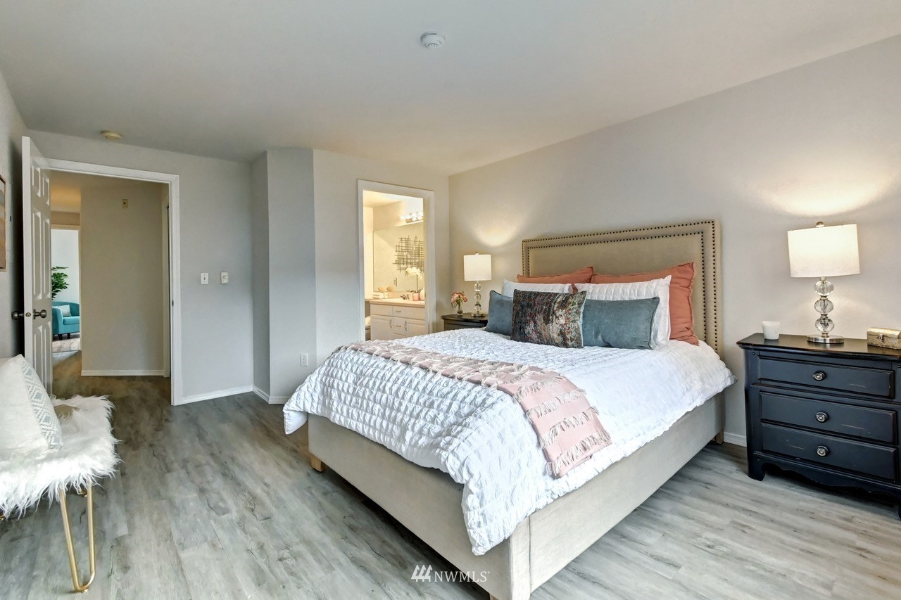 23908 Bothell Everett Highway, Unit B101 Bothell, WA 98021 - Photo 15 of 29 a bedroom with a bed and a mirror