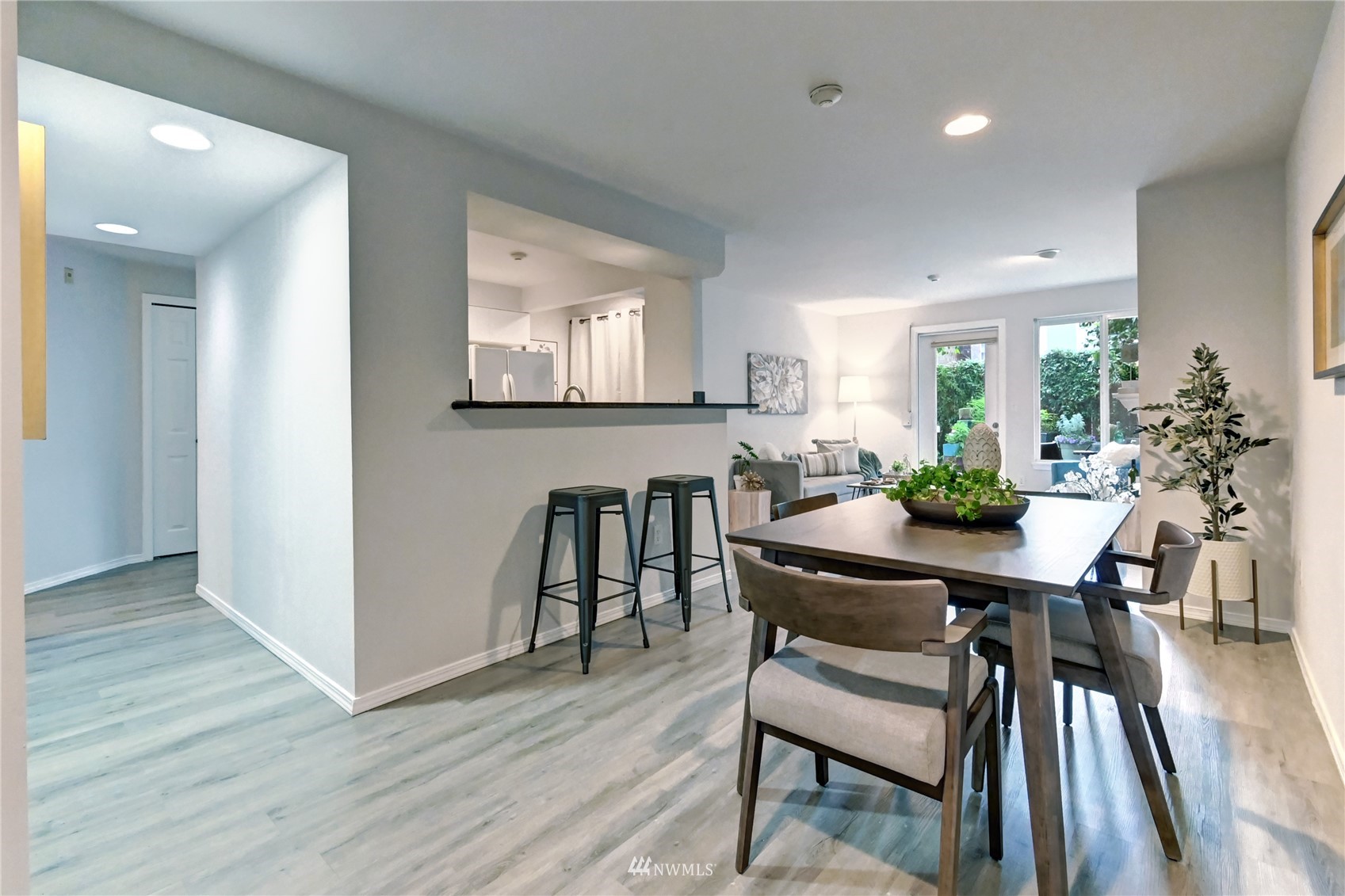 23908 Bothell Everett Highway, Unit B101 Bothell, WA 98021 - Photo 5 of 29 a view of a dining room with furniture and wooden floor