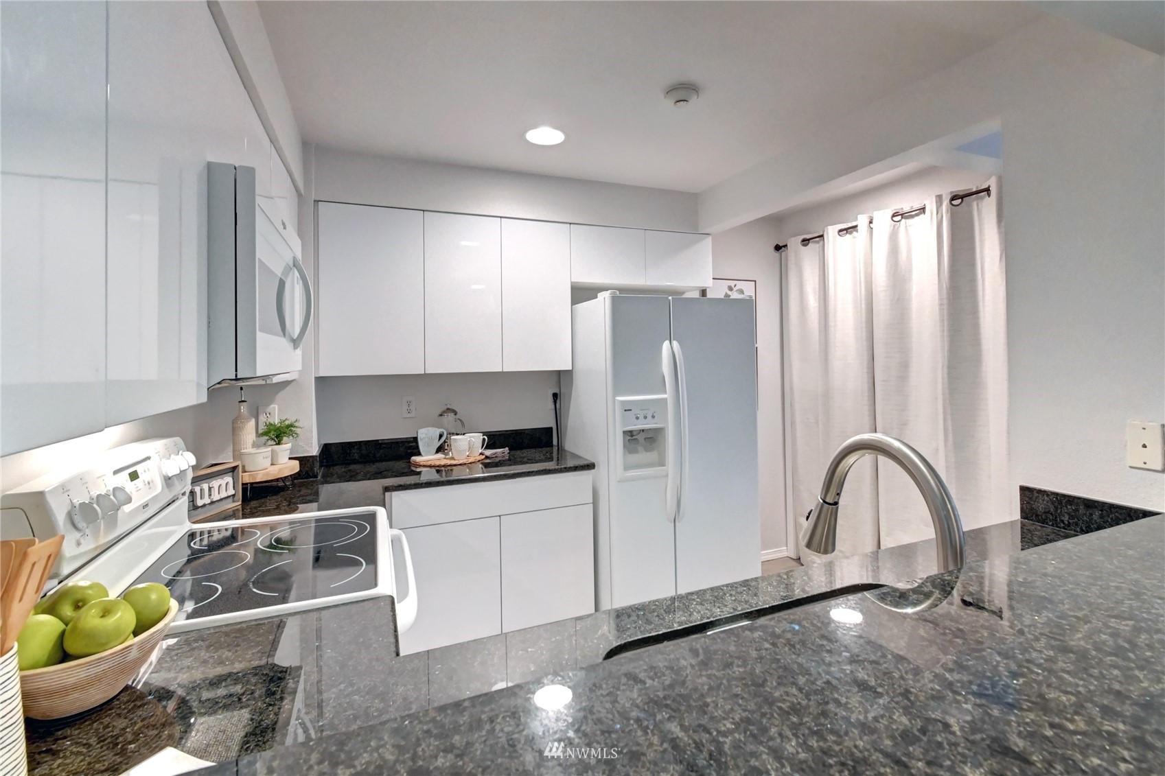 23908 Bothell Everett Highway, Unit B101 Bothell, WA 98021 - Photo 9 of 29 a kitchen with stainless steel appliances granite countertop a stove a sink and a refrigerator