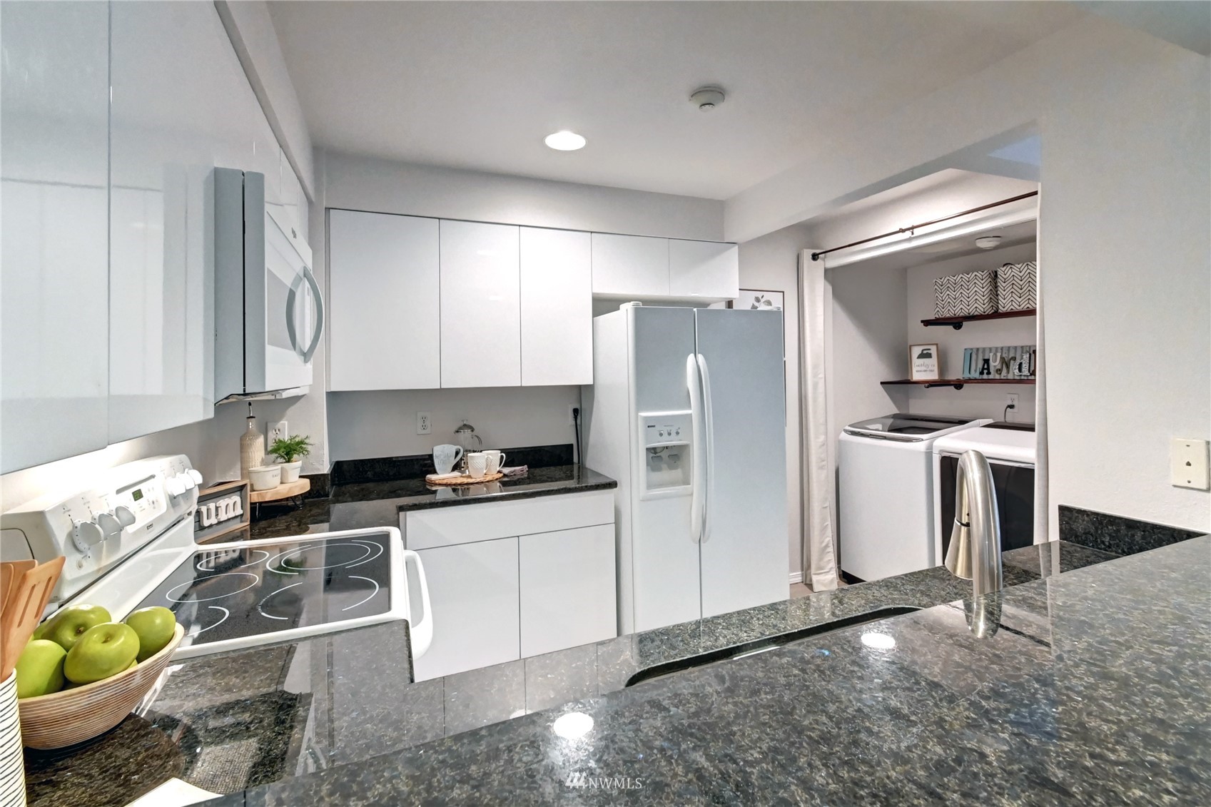 23908 Bothell Everett Highway, Unit B101 Bothell, WA 98021 - Photo 10 of 29 a kitchen with stainless steel appliances a stove a refrigerator and a sink