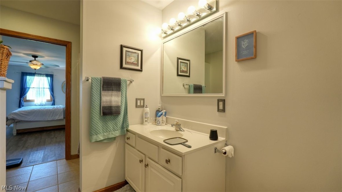63155 Arrowhead Road Cambridge, OH 43725 - Photo 24 of 50 Bathroom featuring ceiling fan, vanity, and tile flooring
