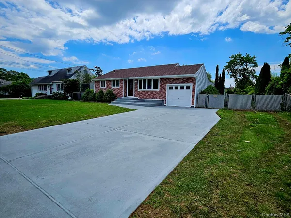 a front view of a house with a garden and yard