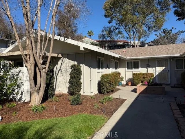 a view of a house with backyard porch and sitting area