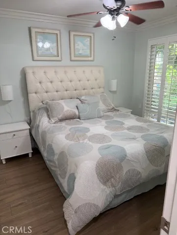a large bed sitting in a bedroom next to a window