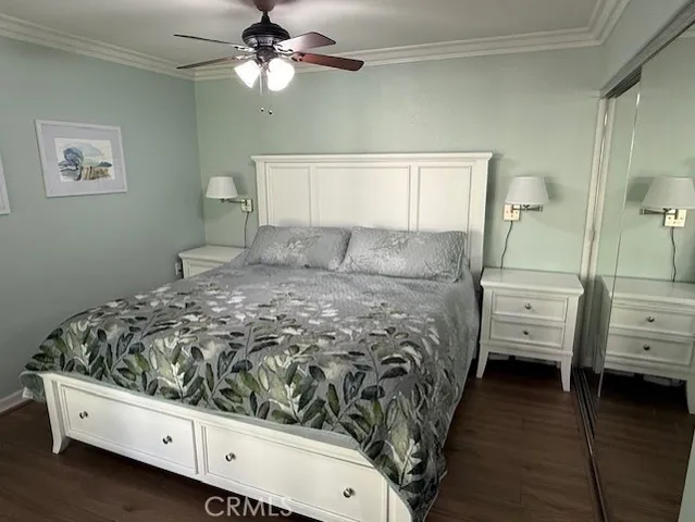 a bedroom with a bed and a ceiling fan