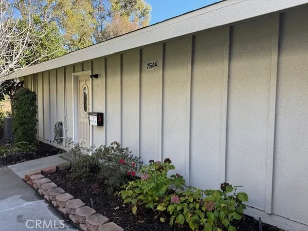 a couple of potted plants in front of door