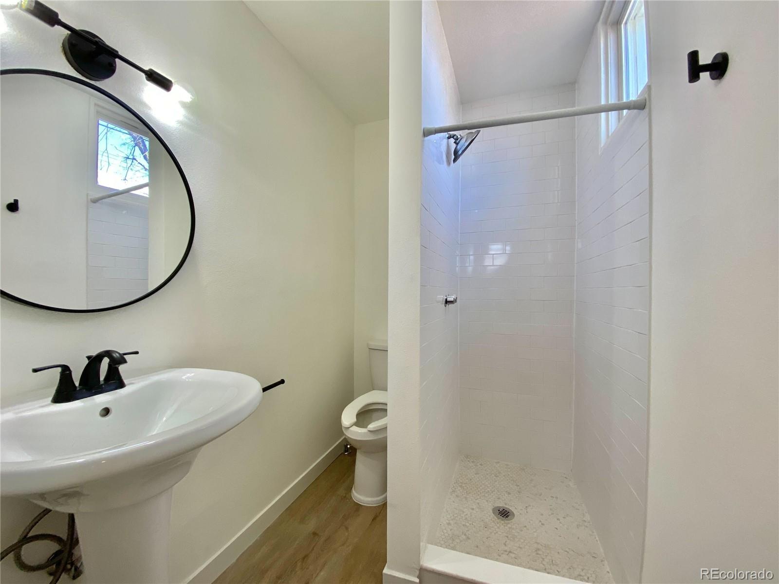 2422 West Vermijo Avenue, Unit 7 Colorado Springs, CO 80904 - Photo 5 of 6 a bathroom with a sink and mirror