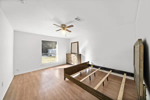a living room with a bed furniture and a window