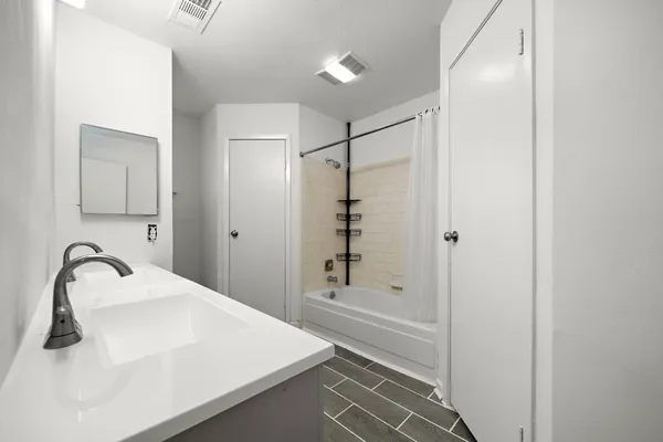 a bathroom with a bathtub and a shower