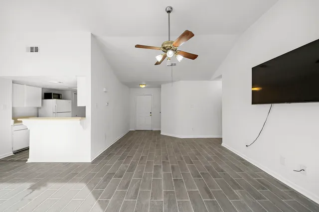 a view of a livingroom with furniture and flat screen tv