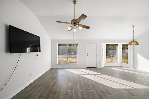 a living room with a flat screen tv and a window