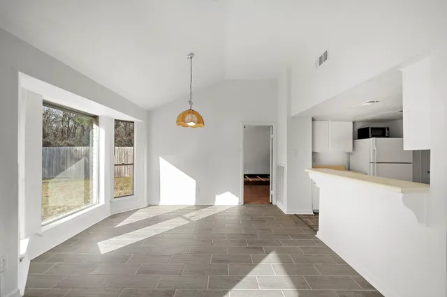a view of a kitchen with a sink and dishwasher wooden floor