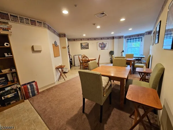 a dining room with furniture and a floor to ceiling window