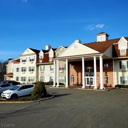 a front view of a house with a garden and balcony