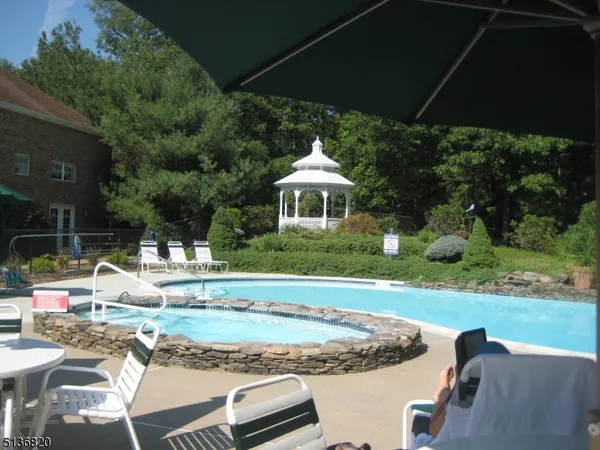 a view of a house with backyard porch and sitting area