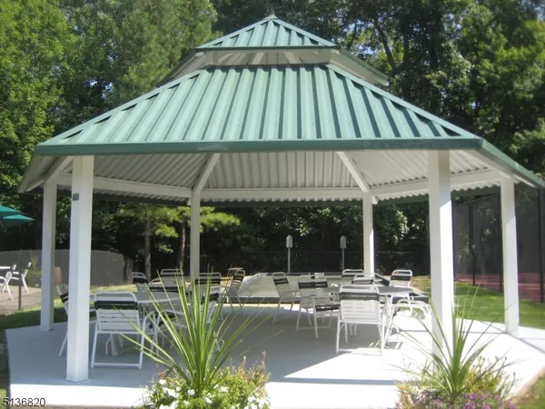 a view of patio with a table and chairs under an umbrella