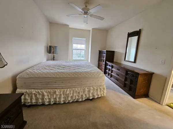 a bedroom with a bed dresser and a window