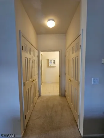 a view of a hallway with wooden walls