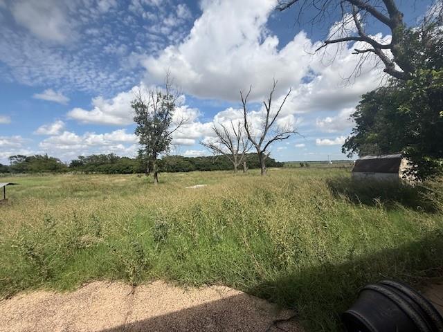 909 Railroad Street Rochester, TX 79544 - Photo 18 of 19 a view of a lake with a yard and large trees