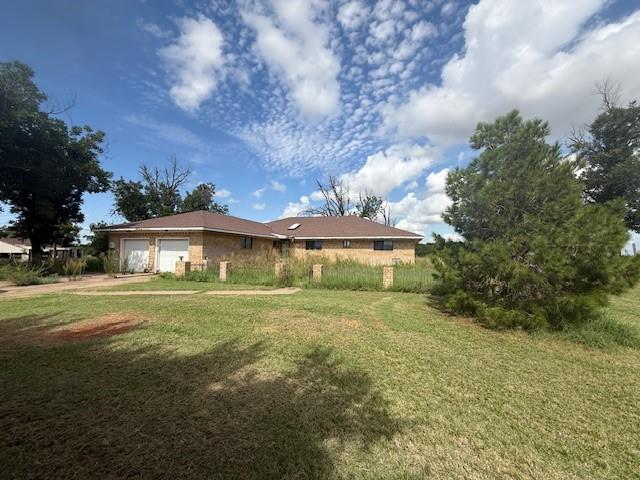 909 Railroad Street Rochester, TX 79544 - Photo 2 of 19 a view of a big house with a big yard and large trees