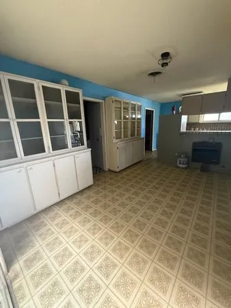 a large kitchen with stainless steel appliances a sink and a counter top space
