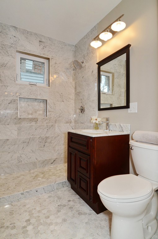 19 Rill Street, Unit 2 Boston, MA 02125 - Photo 13 of 19 a bathroom with a toilet sink and mirror