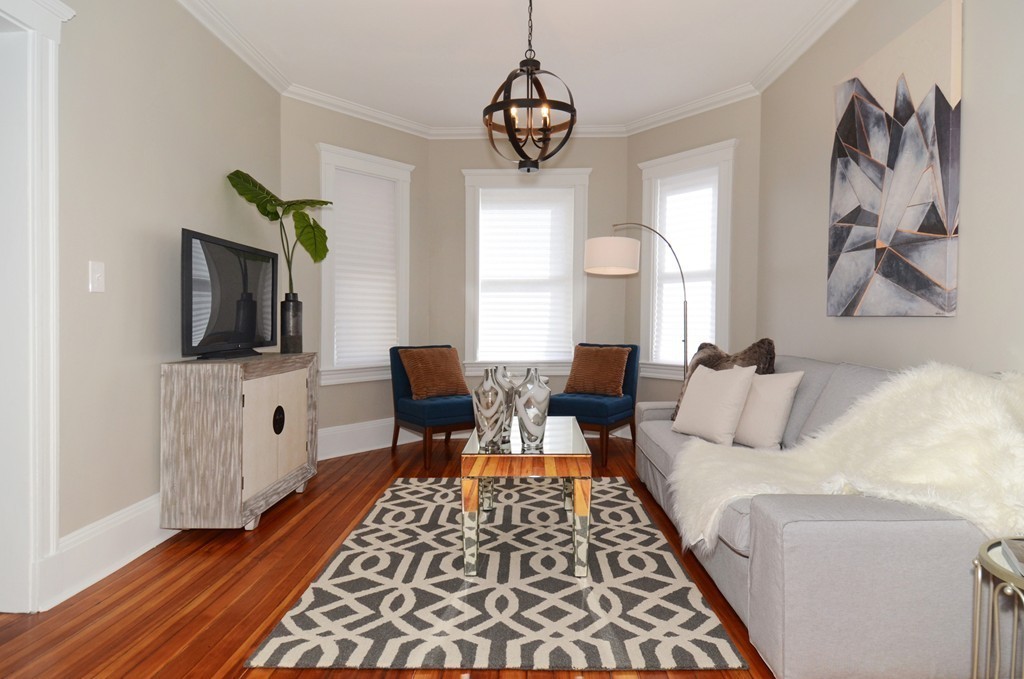 19 Rill Street, Unit 2 Boston, MA 02125 - Photo 5 of 19 a living room with furniture a window and a flat screen tv