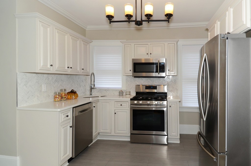 19 Rill Street, Unit 2 Boston, MA 02125 - Photo 7 of 19 a kitchen with stainless steel appliances a stove a refrigerator and a sink