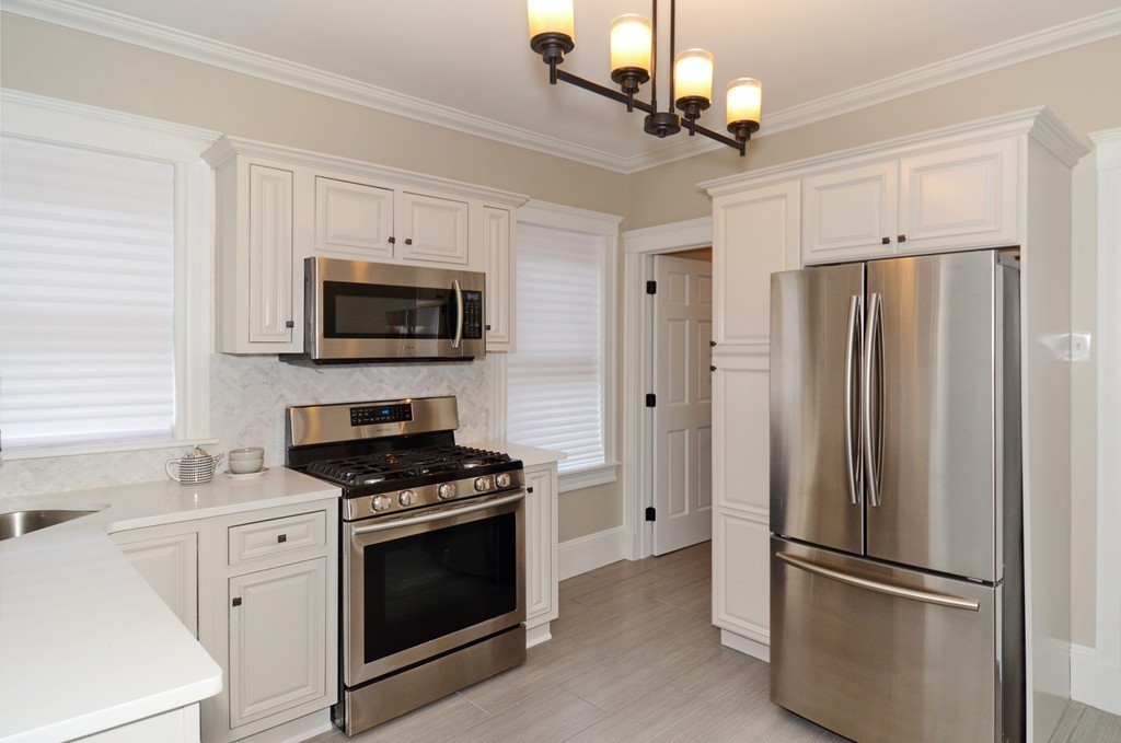 19 Rill Street, Unit 2 Boston, MA 02125 - Photo 8 of 19 a kitchen with stainless steel appliances granite countertop a refrigerator stove and microwave