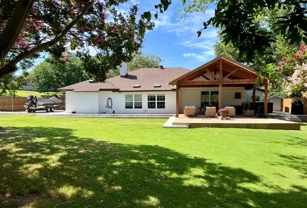 a front view of a house with swimming pool having outdoor seating