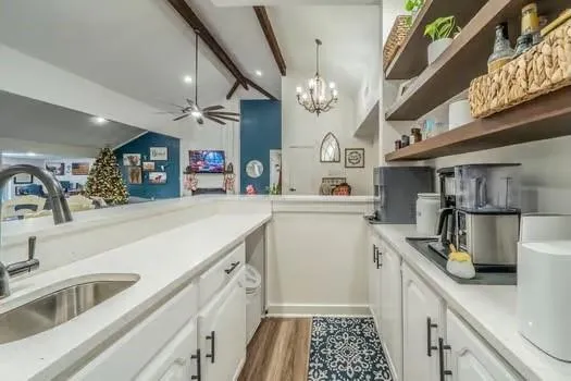 a kitchen that has a lot of cabinets in it