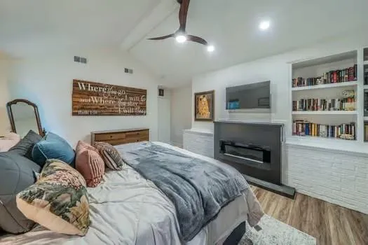 a bedroom with a bed and a book shelf