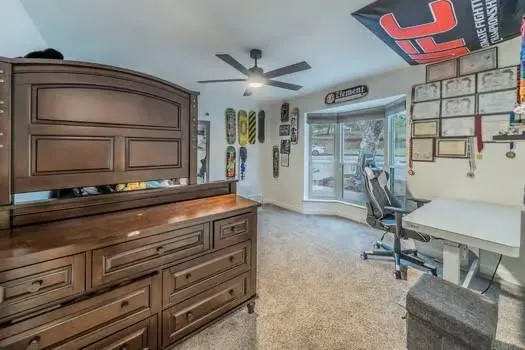 a living room with furniture a flat screen tv and gym equipment