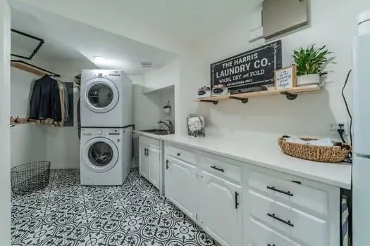 a utility room with sink dryer and washer