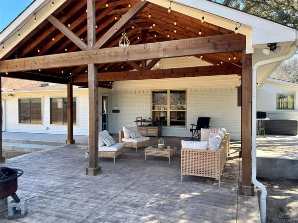 a living room with patio furniture and a fireplace