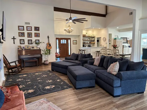 a living room with furniture a fireplace and a flat screen tv