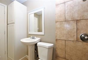 2527 Oakcliff Street Houston, TX 77023 - Photo 11 of 15 a bathroom with a sink and a mirror