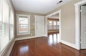 2527 Oakcliff Street Houston, TX 77023 - Photo 3 of 15 a view of an empty room with wooden floor and a window